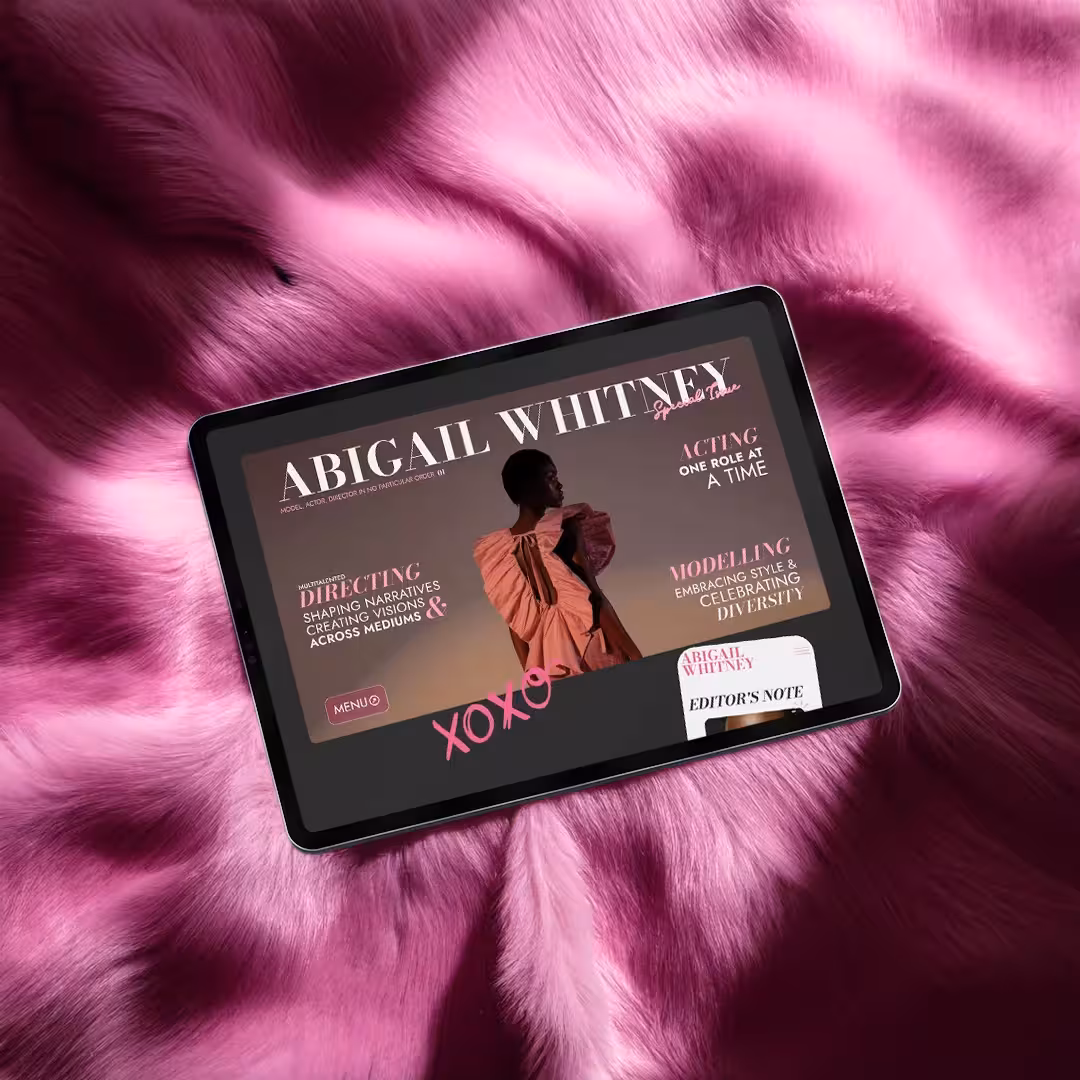 Ipad on a fur blanket displaying the main page of Abigail Whitney's website.