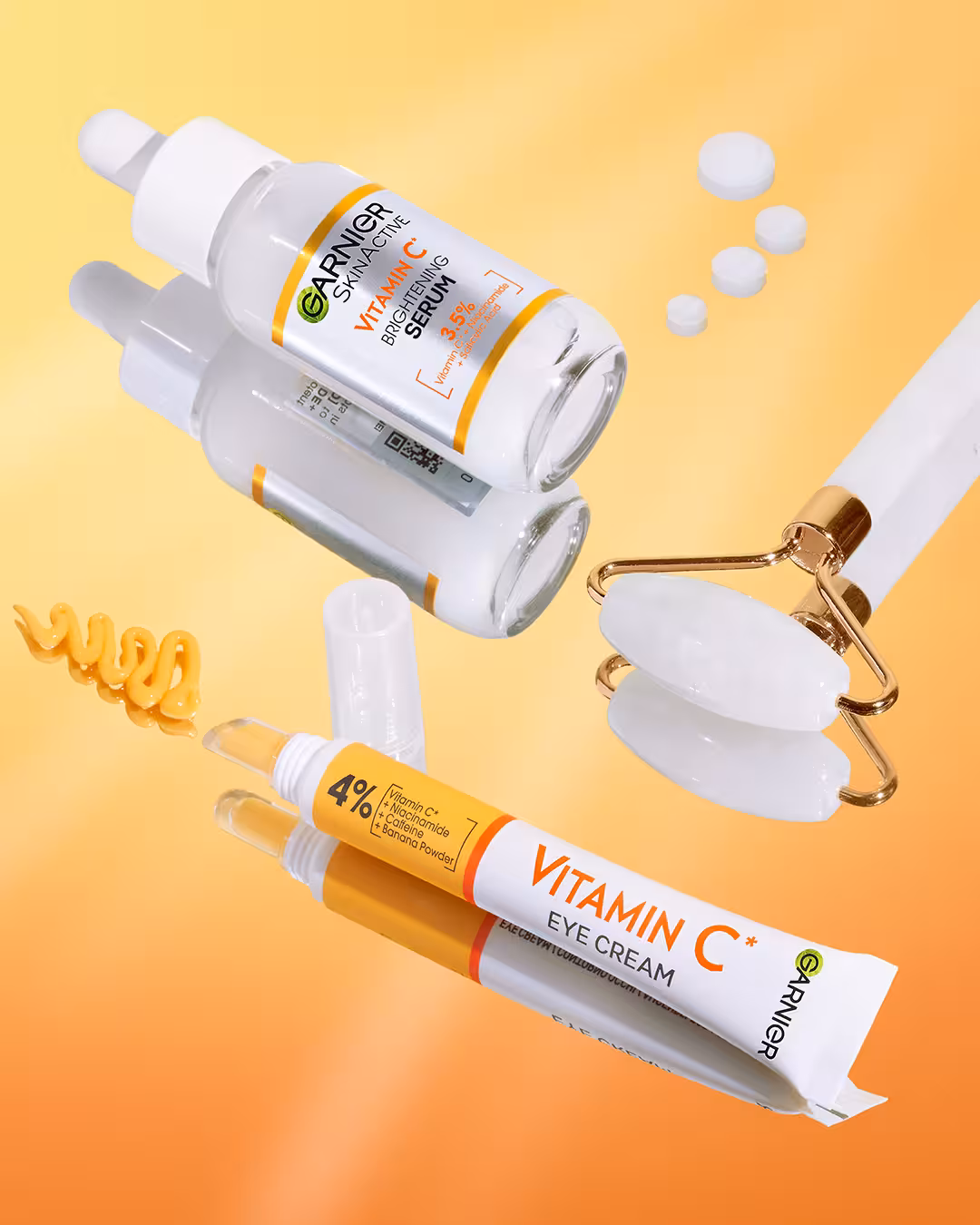 Garnier SkinActive Vitamin C Eye Cream and Brightening Serum displayed with a white jade roller and product texture swatch.