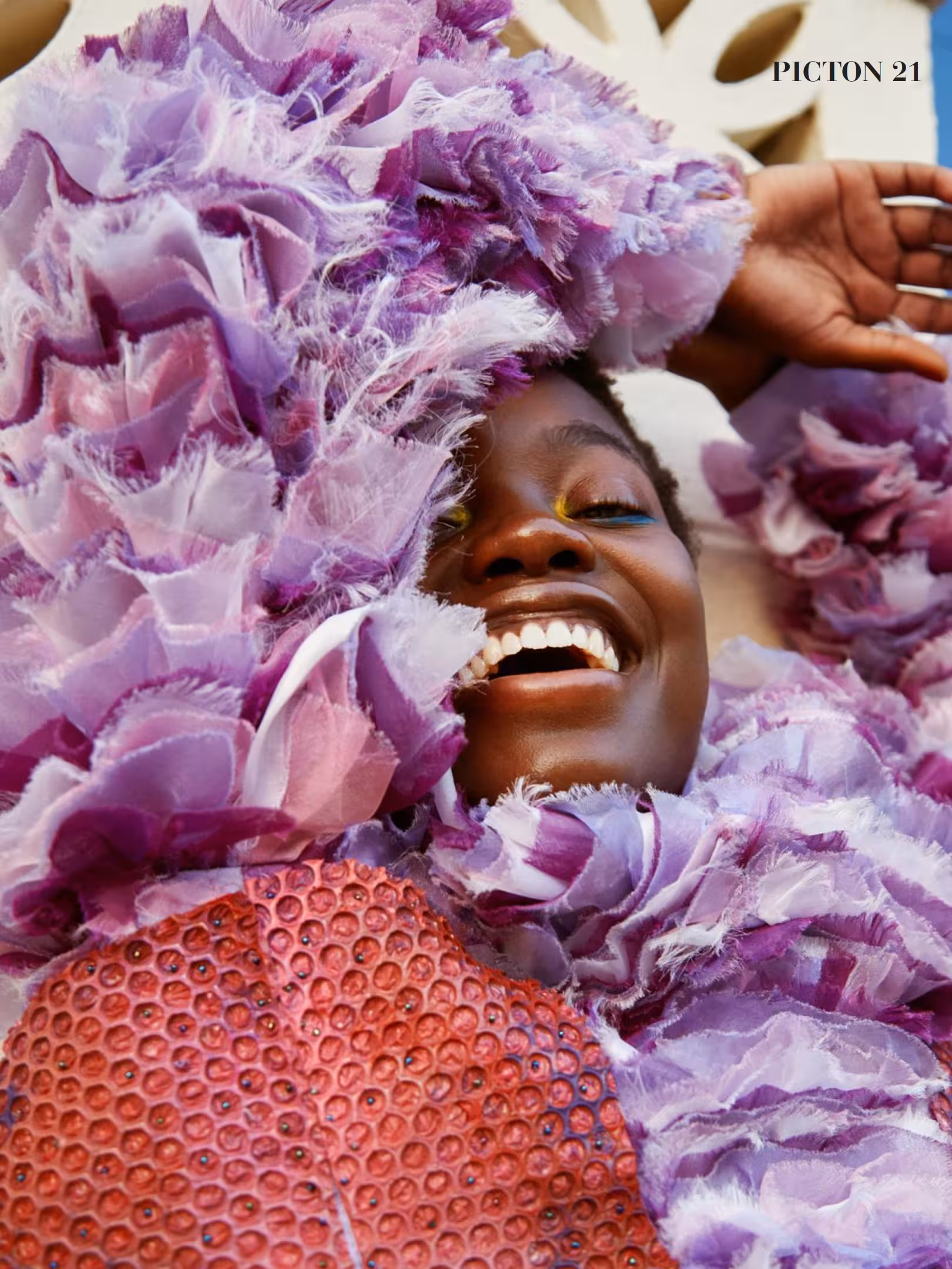 Abigail Whitney laughing while surrounded by voluminous lilac ruffles, editorial spread in Picton Magazine.