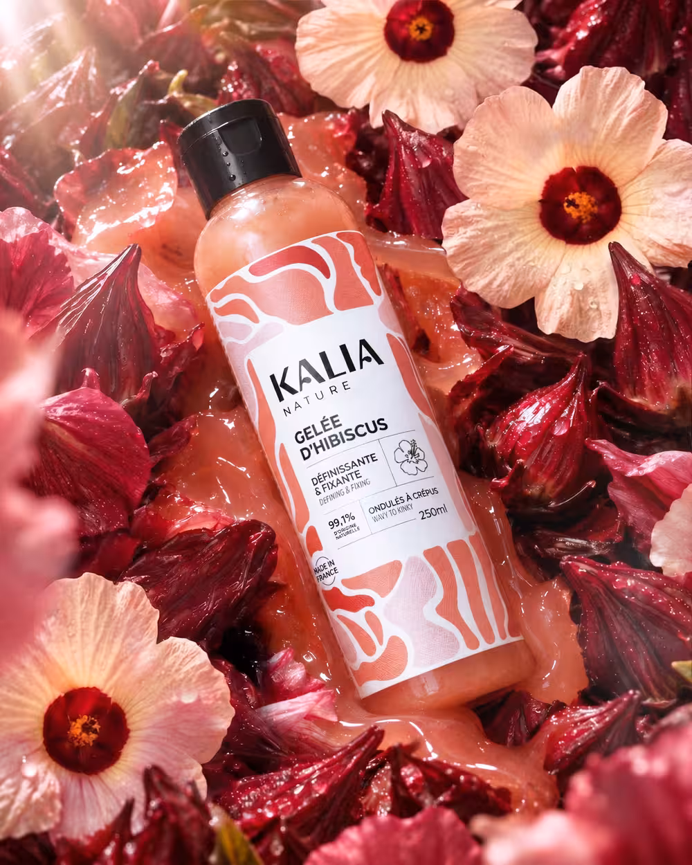 Kalia Nature campaign image featuring Hibiscus Styling Gel surrounded by red hibiscus flowers and calyces on a glossy pink gel texture.